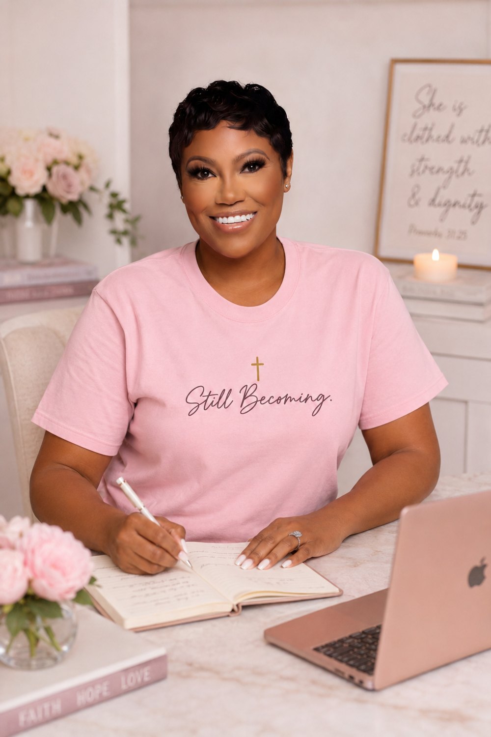 Autumn V. Dillon smiling at her desk, journaling